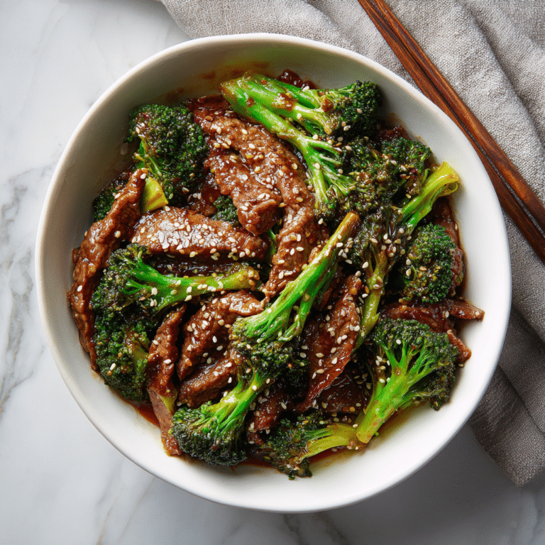 Takeout-style beef and broccoli stir-fry coated in a glossy sauce, served as a homemade dinner.