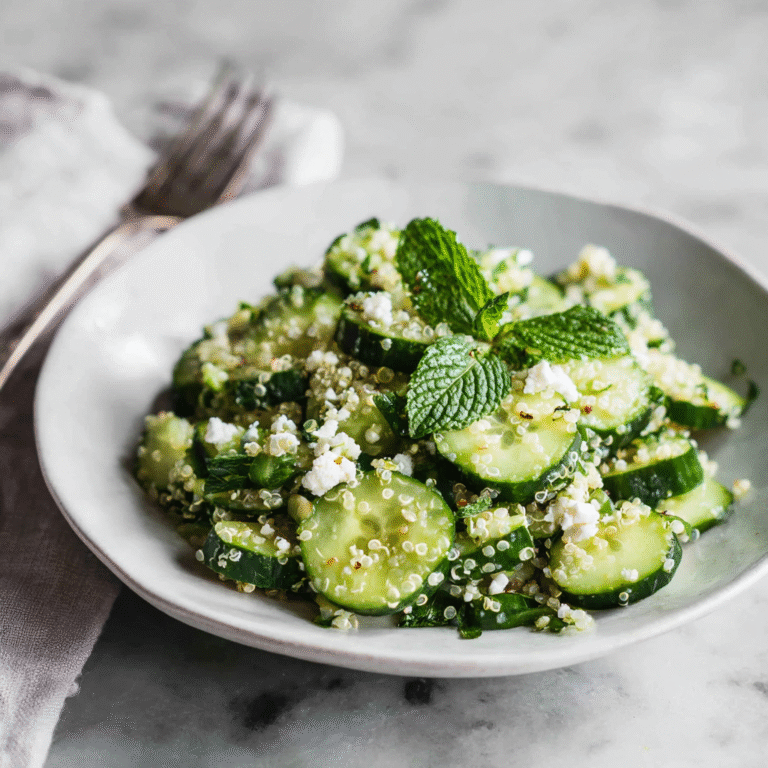 Cucumber quinoa feta salad with fresh herbs and a light lemon dressing, served as a bright and healthy dish.