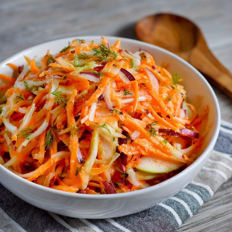 All ingredients for carrot apple salad laid out on a white kitchen counter ready to be prepared