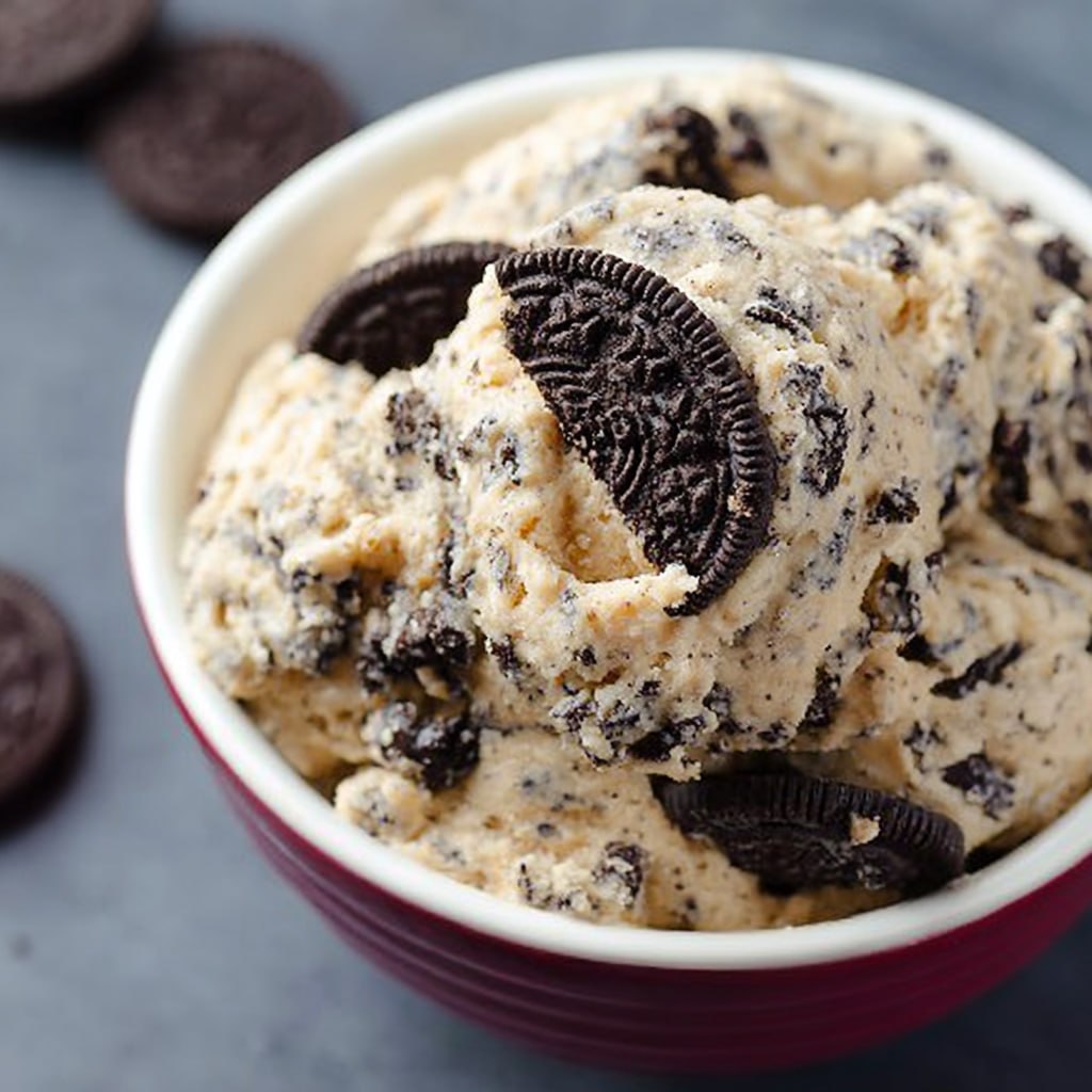 Finished no-bake Oreo cookie dough served in a bowl with extra Oreo crumbles